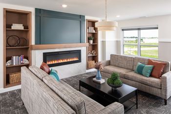the preserve at gateway living room with couches and a fireplace